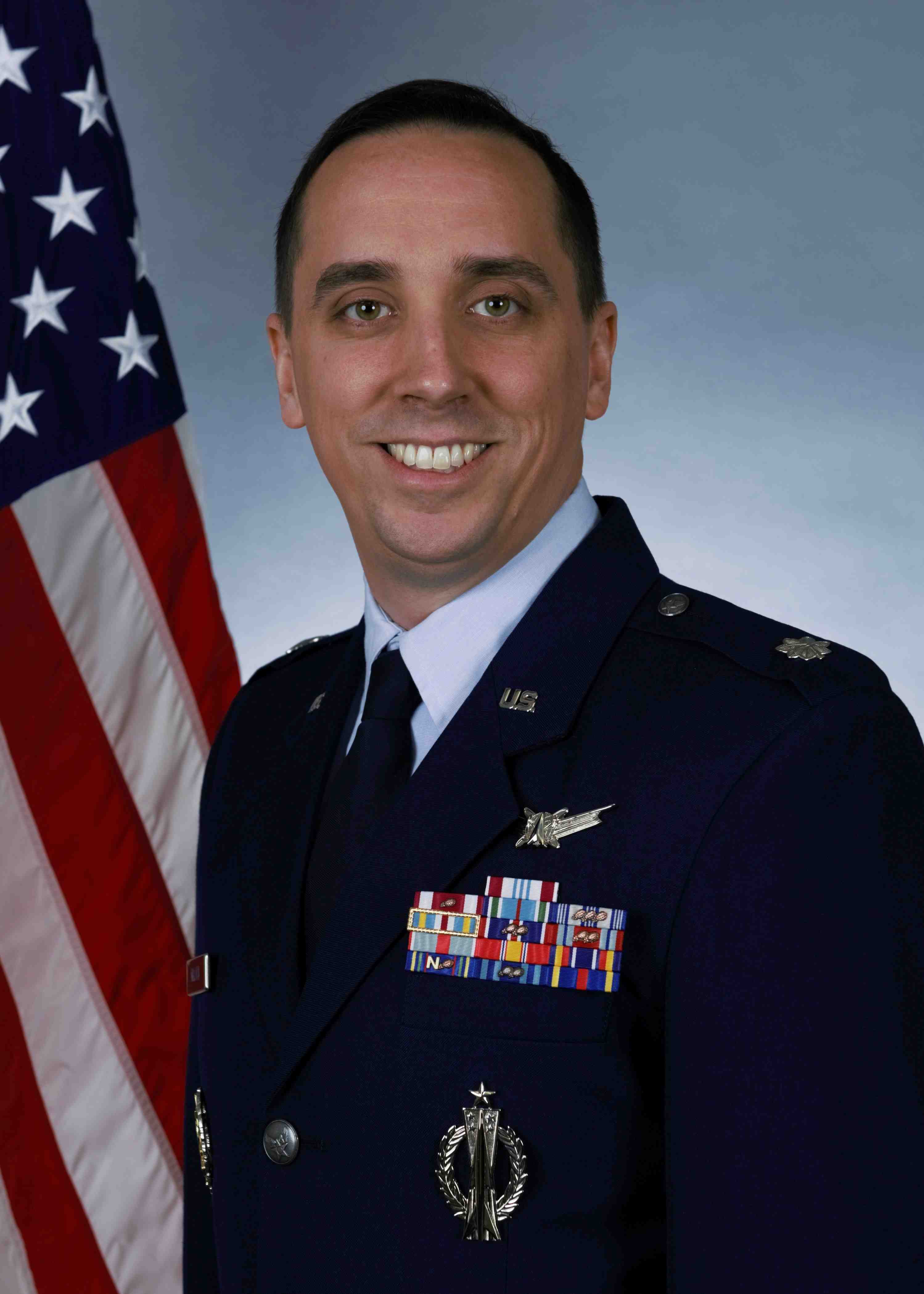 Lt Col Ross V. Millard in front of the US Flag