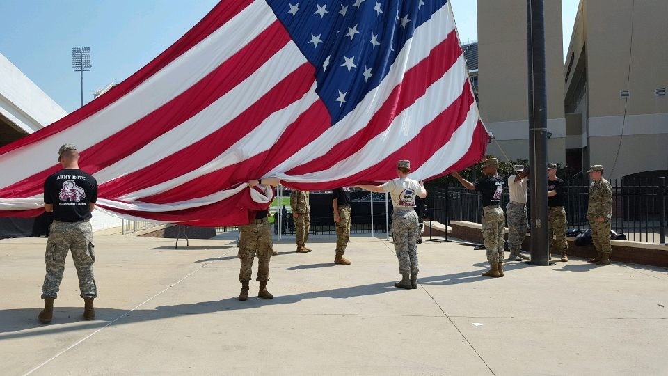 Army and Air Force ROTC Cadets raise the garrison flag before kickoff