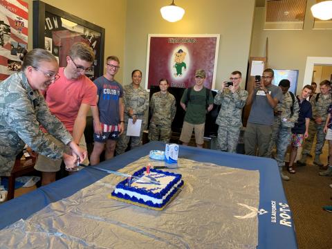 Oldest and Youngest Airmen cut the Air Force Birthday Cake with cadets looking on