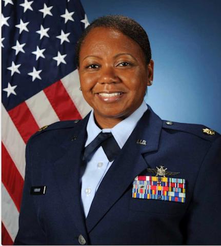 Maj Kanesha Webber in front of the American Flag
