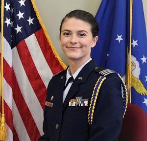Cadet Olivia Sekyra with uniform. American and Air Force Flags are behind her.